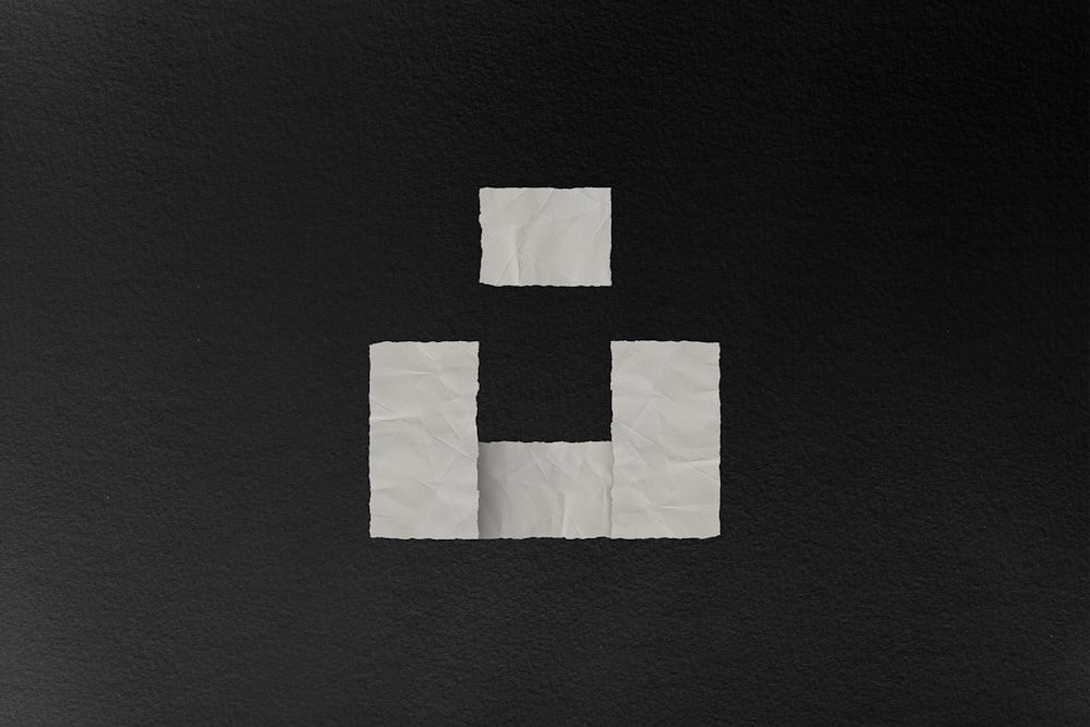 a black and white photo of a piece of paper with the letter h on it