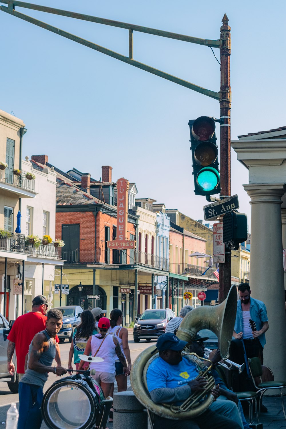 a group of people standing on the side of a street