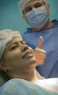 Smiling medical professional reviewing surgical data on a sleek dashboard.