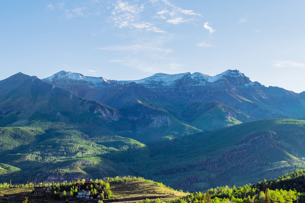 a view of a mountain range with a house in the foreground