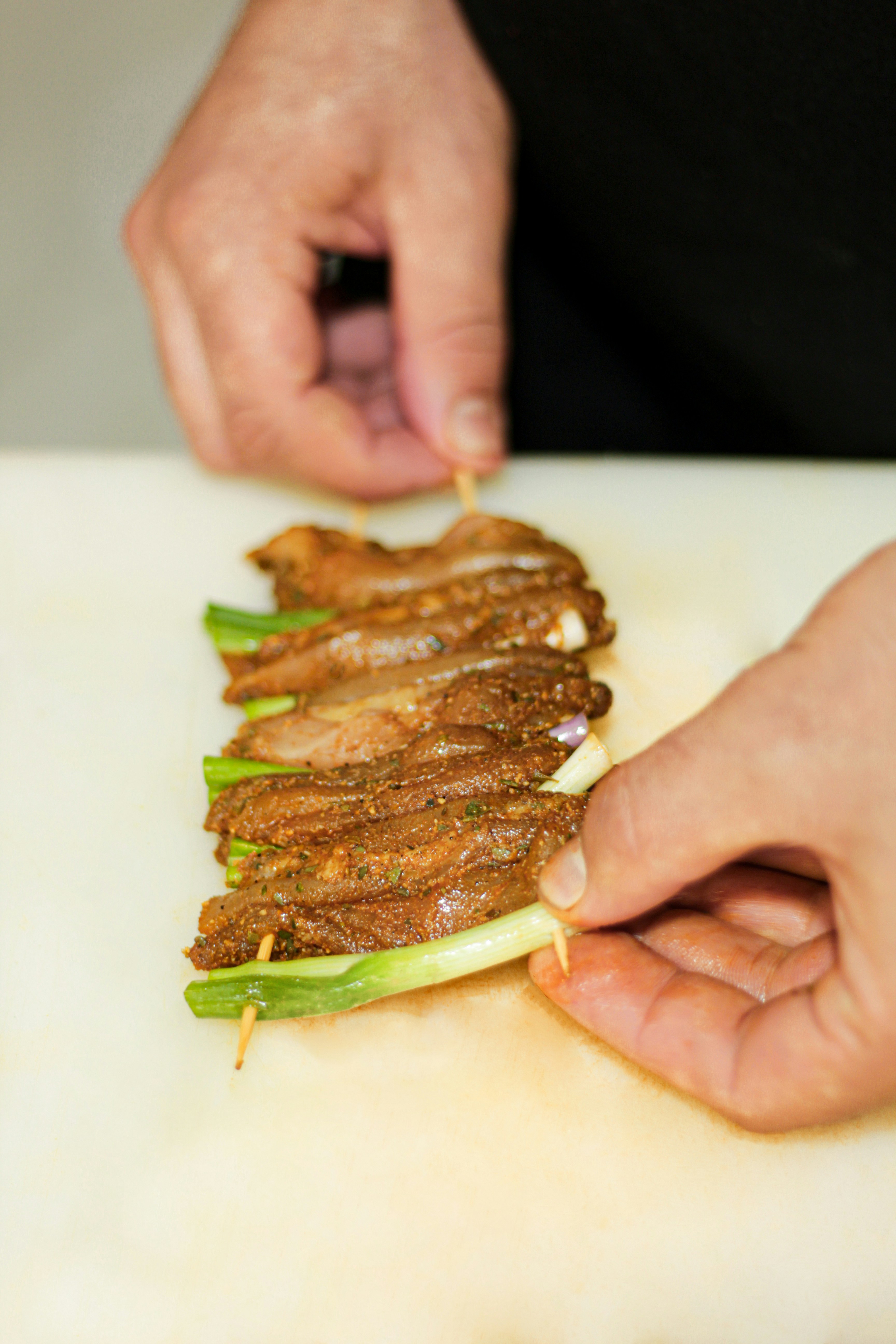 a person preparing food on a cutting board
