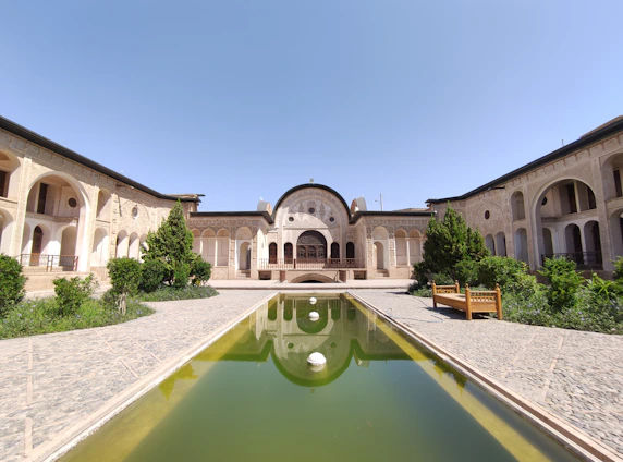 A peaceful courtyard of a Mathura apartment complex with traditional Indian architectural elements.