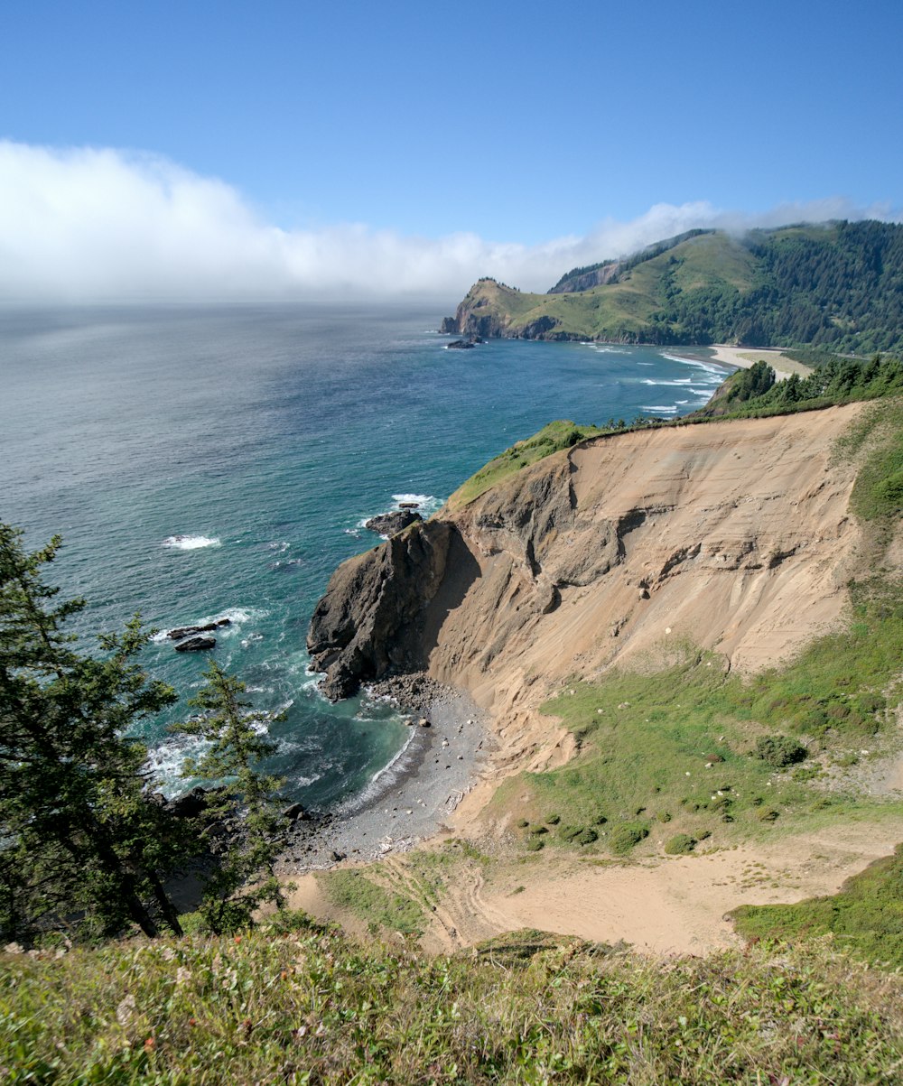 a view of the ocean from the top of a hill