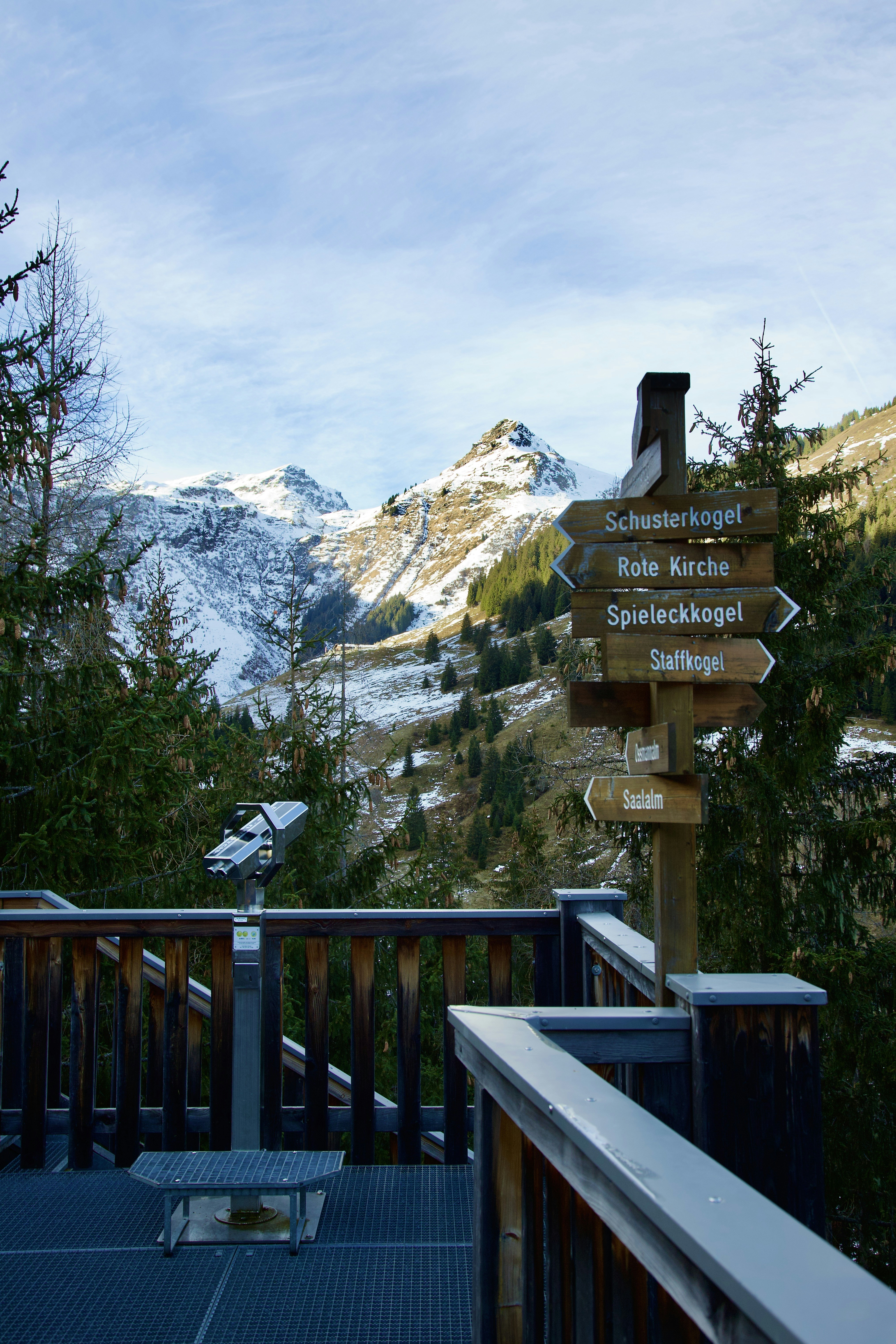 a wooden sign pointing in different directions