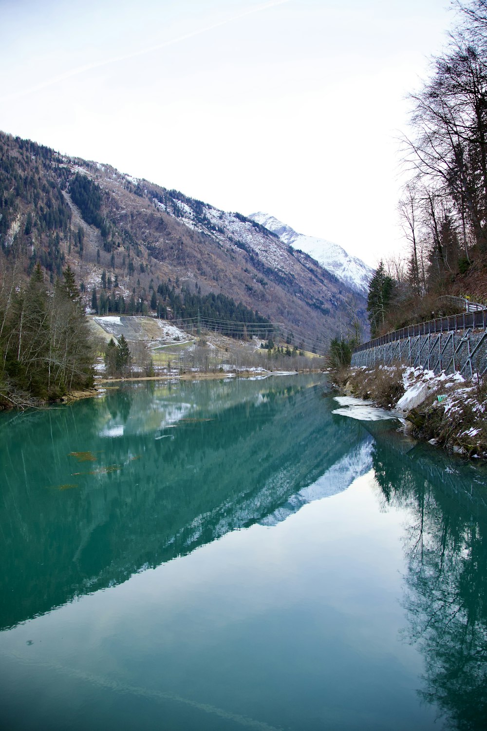 a body of water with a mountain in the background