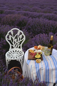 a table with a plate of food and a bottle of wine