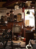 a room filled with lots of clutter and a tv