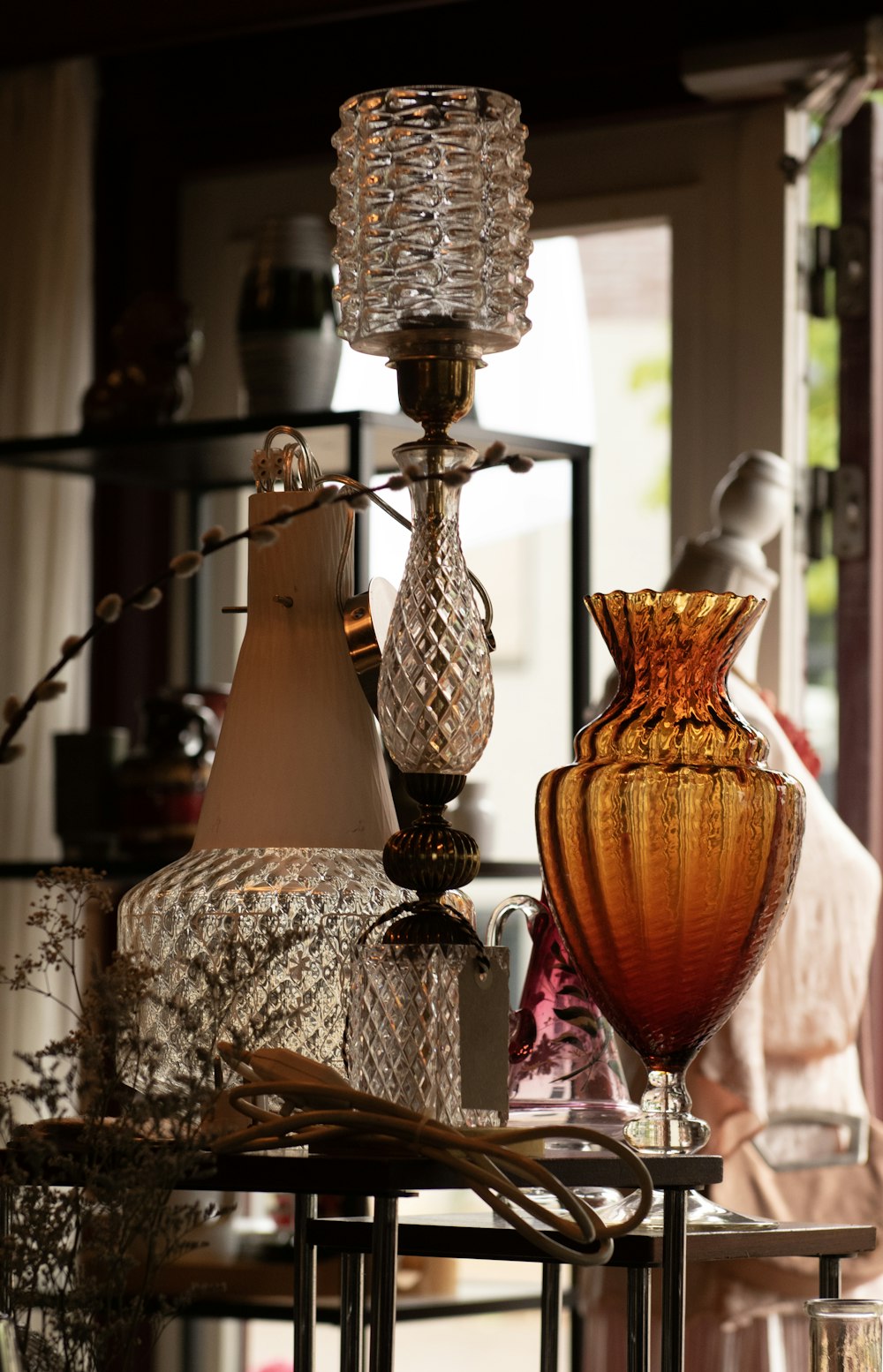 a table topped with lots of glass vases