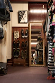 An over-the-door shoe organizer filled with various shoes in a cozy bedroom setting.