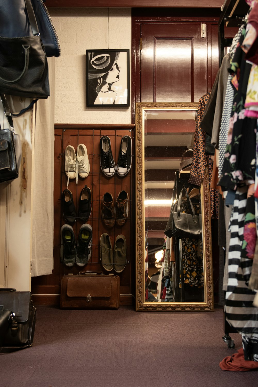 a closet filled with shoes and a large mirror