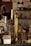 A collection of vintage items and antiques displayed, including a brass instrument resembling a trombone, a decorative lantern, a small statue of a deity, and various other brass objects.