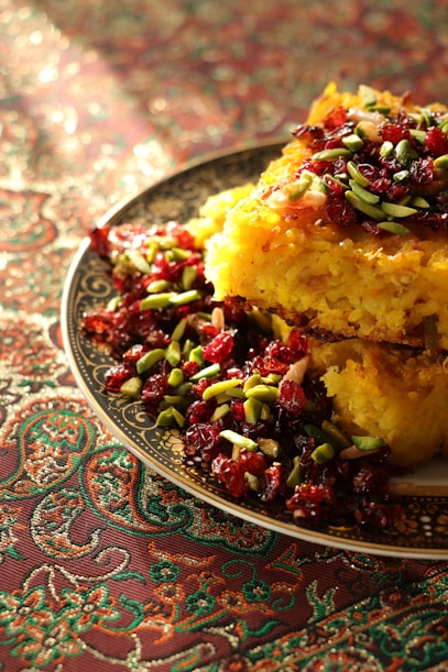 a plate of food with cranberries and pistachio