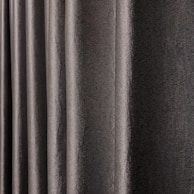 A close-up view of dark, textured drapery fabric with waves and folds creating a sense of movement. The material appears slightly shiny, indicating a smooth finish.