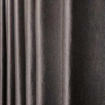 A close-up view of dark, textured drapery fabric with waves and folds creating a sense of movement. The material appears slightly shiny, indicating a smooth finish.