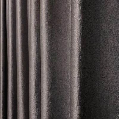 A close-up view of dark, textured drapery fabric with waves and folds creating a sense of movement. The material appears slightly shiny, indicating a smooth finish.