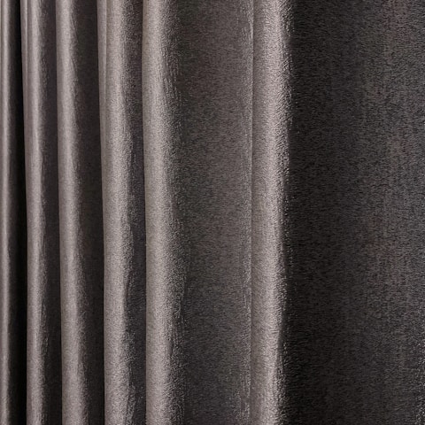 Close-up of a black and dusty green geometric patterned fabric draped softly.