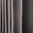 Vertical folds of a dark gray, textured fabric, resembling curtain pleats, evenly spaced.