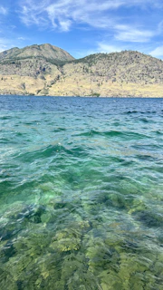 Close-up of crystal-clear water with gentle ripples reflecting a blue sky