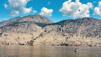 A serene landscape with a person enjoying outdoor sports activities.
