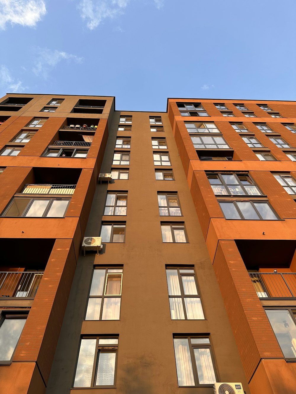 a tall orange building with lots of windows