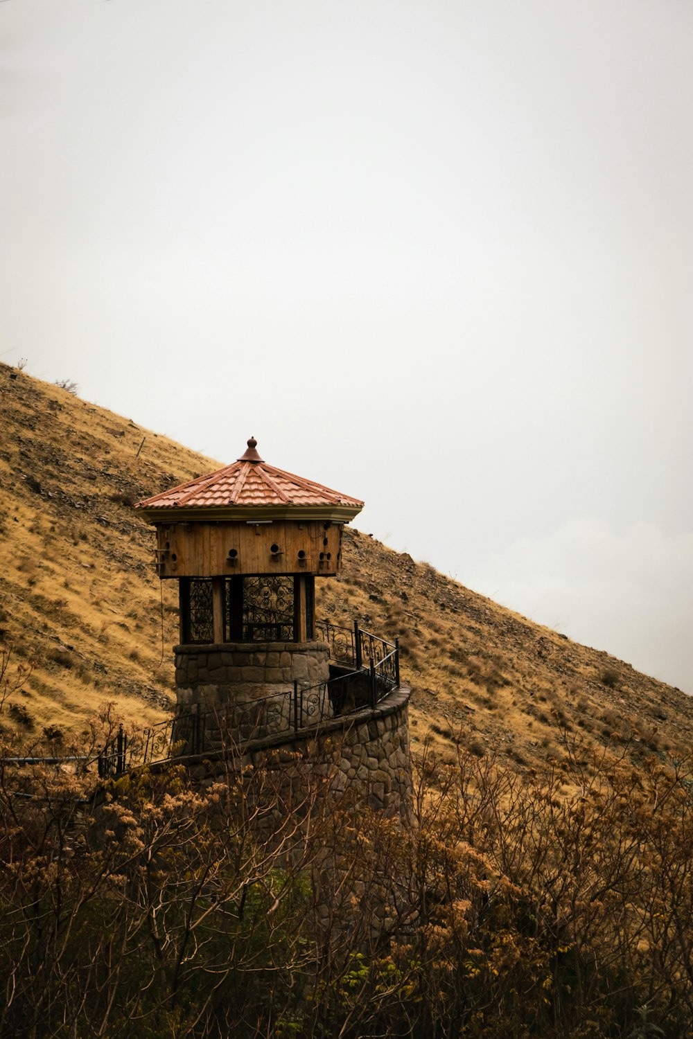 a small building sitting on top of a hill