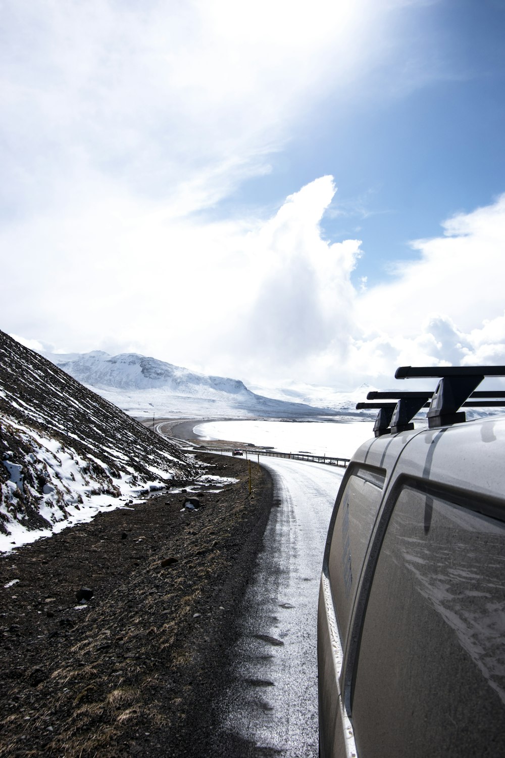 a car driving down a snow covered road