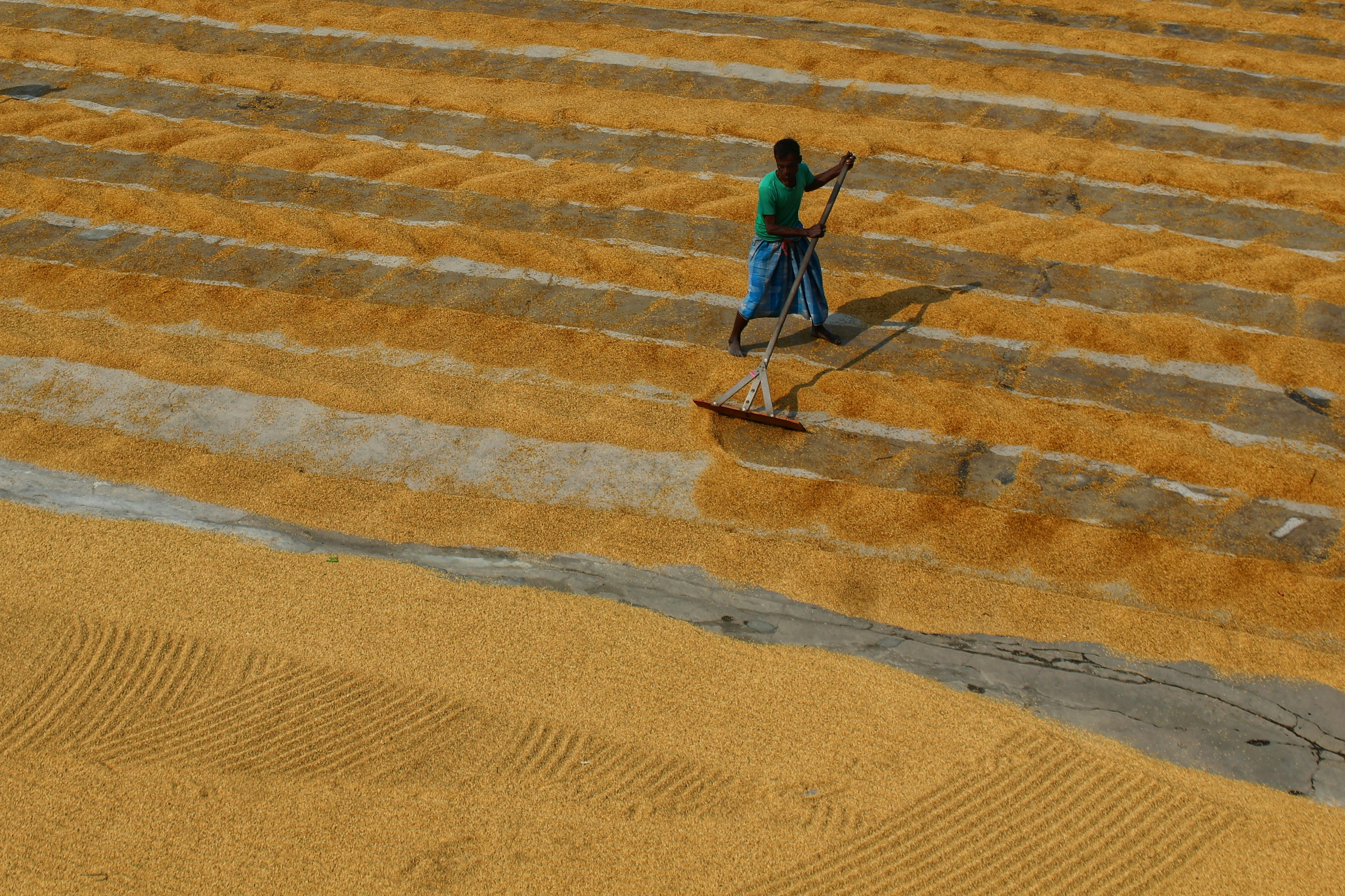a man with a mop and bucket in a field