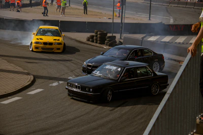 An aerial view of a drift event showing cars carving tight corners.