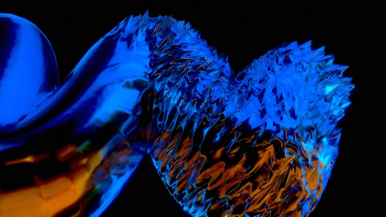 An abstract, digital artwork featuring a shiny, metallic texture interwoven with jagged, crystalline shapes. Vibrant blue and fiery orange colors dominate the twisted and intricate composition, set against a dark background that enhances the glowing effect.