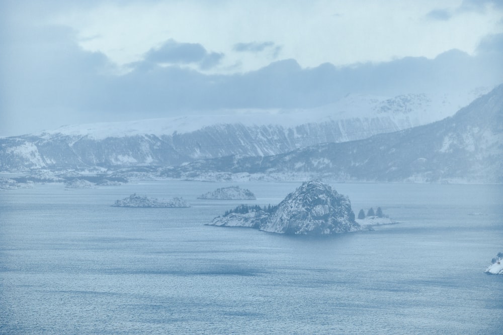 a large body of water surrounded by snow covered mountains