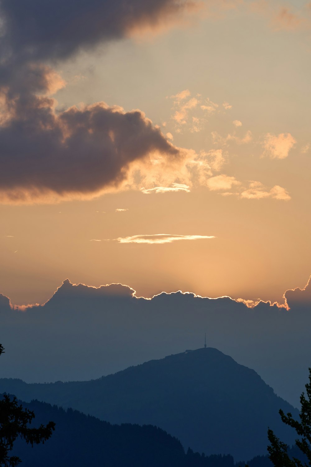 the sun is setting over a mountain range