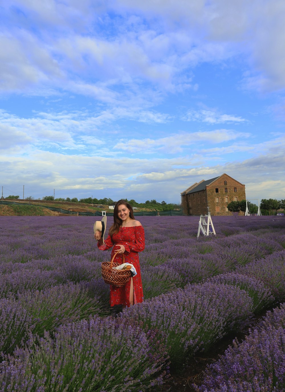 a woman in a red dress standing in a lavender field