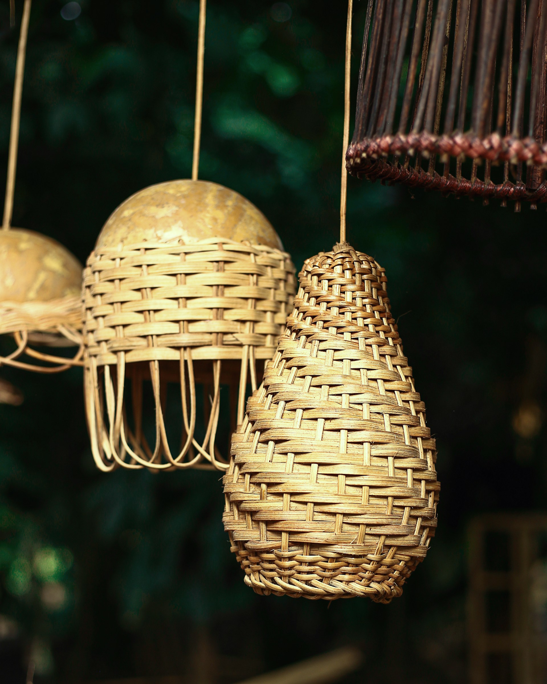 a bunch of hanging lights made of wicker