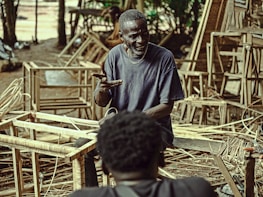 An elderly man receiving gentle assistance during a health workshop at a nursing home.
