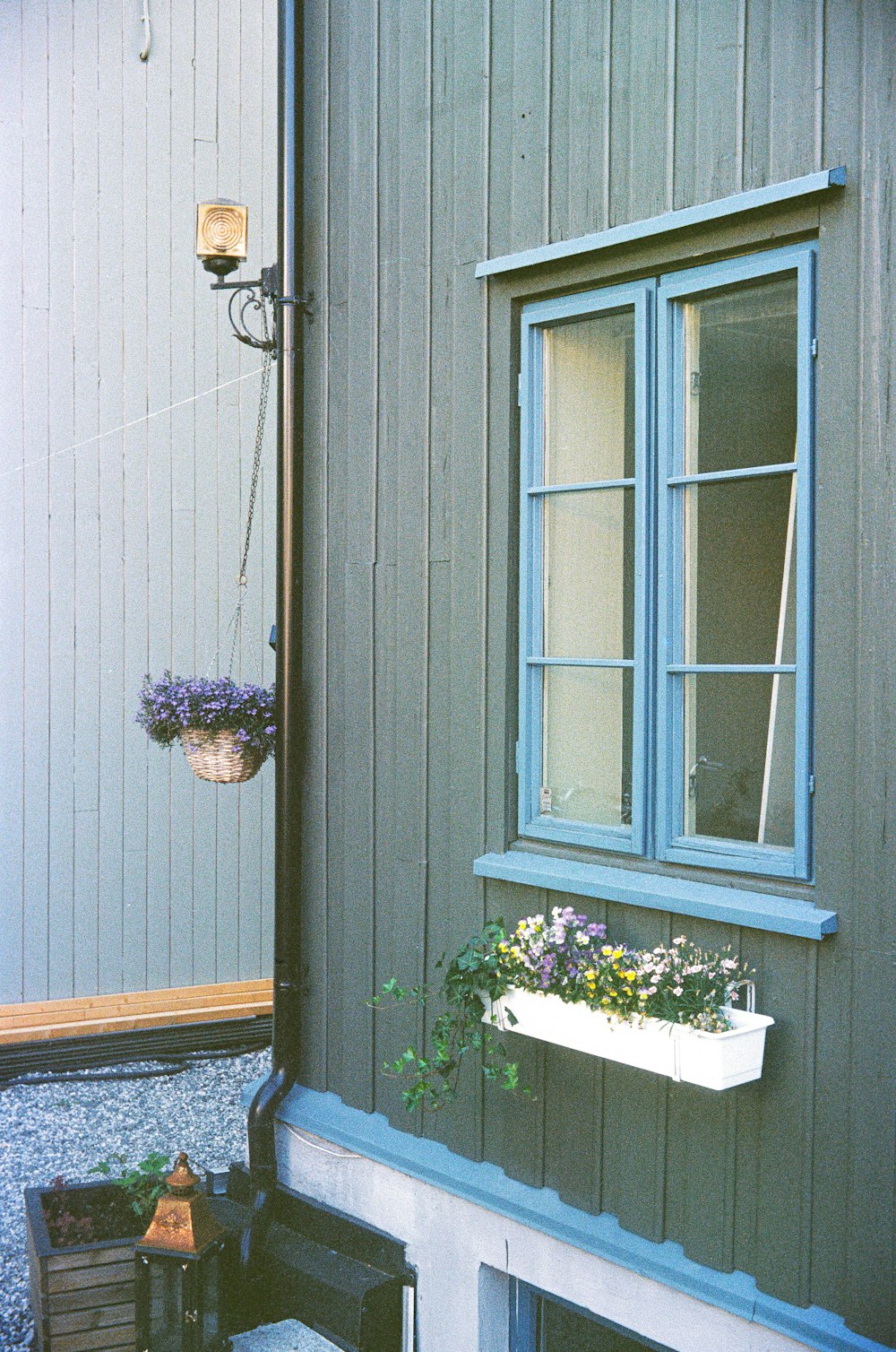 a house with a window and a planter in front of it