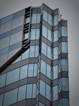 Contemporary office building featuring glass facade and geometric shapes.