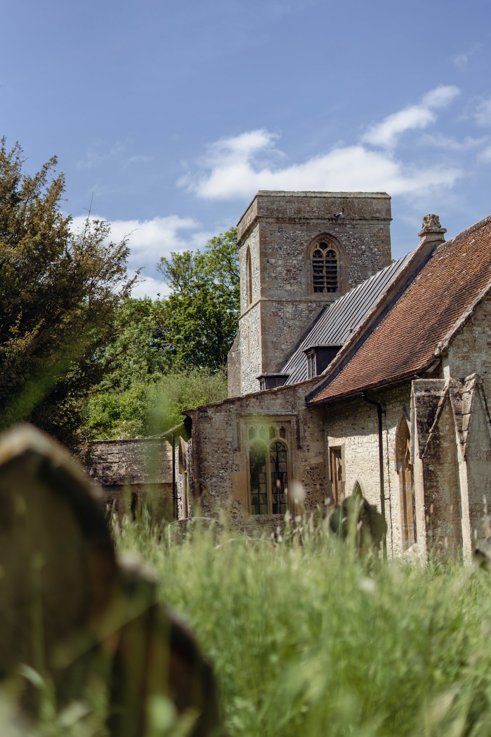 an old church in the middle of a field