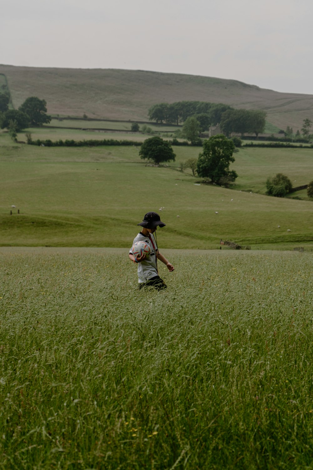 a person walking through a field of grass