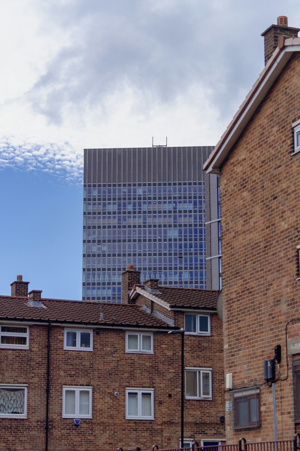 a tall brick building next to a tall brick building