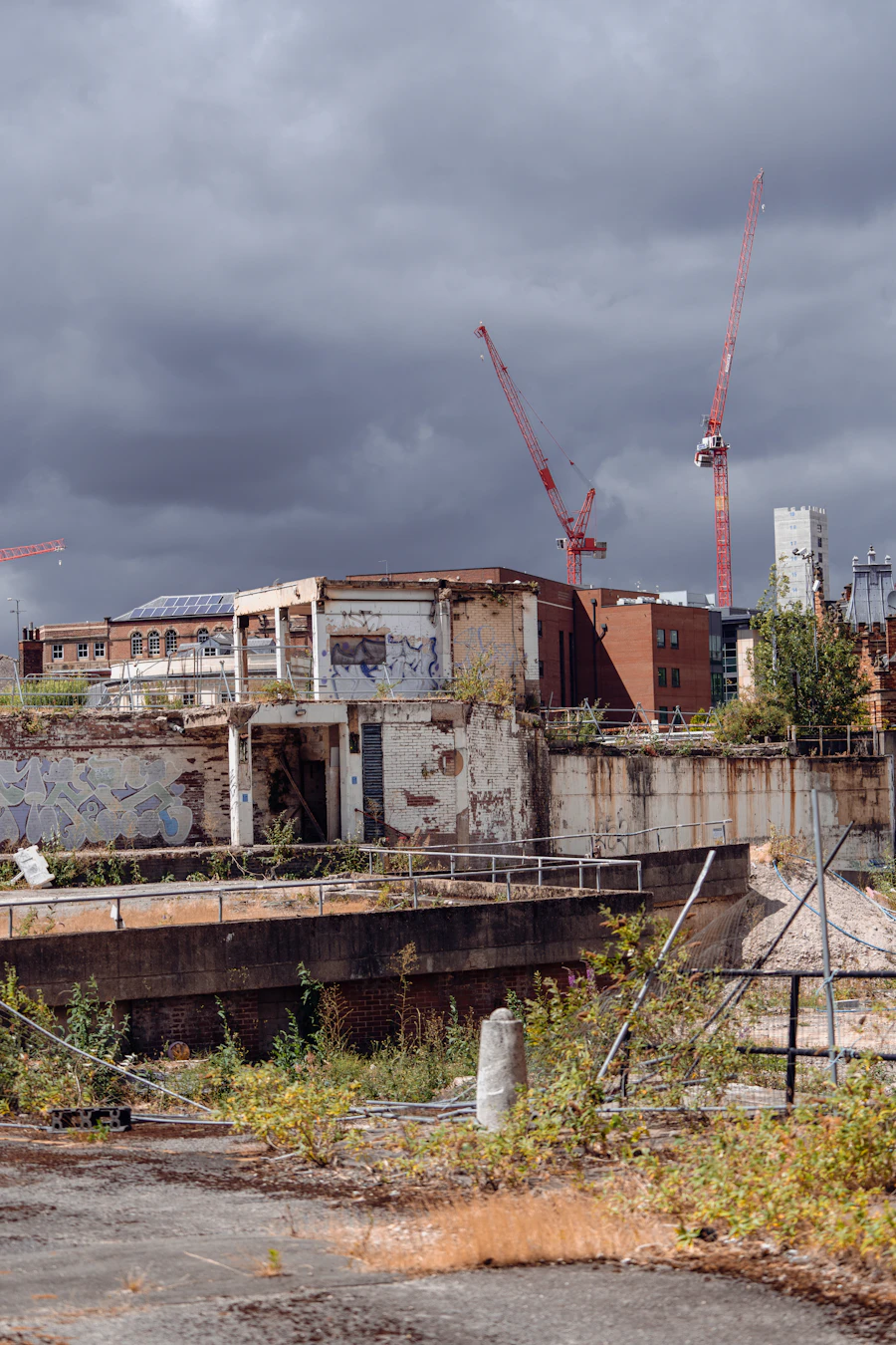 Construction cranes beside a large building in Sheffield, a city that keeps growing as people arrive for work and study