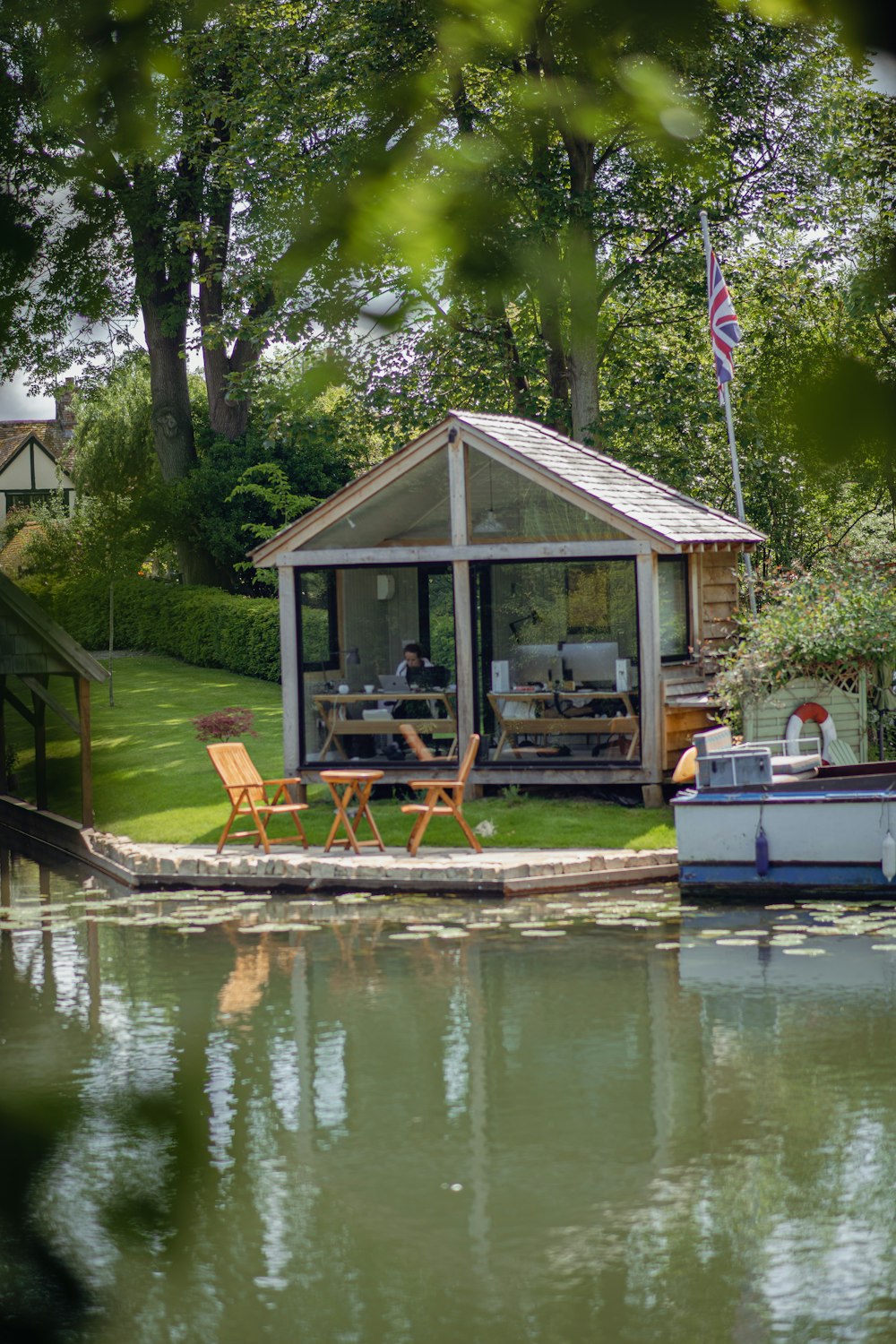 a boat is docked in the water next to a house