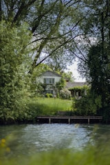 a house sitting on top of a lush green hillside