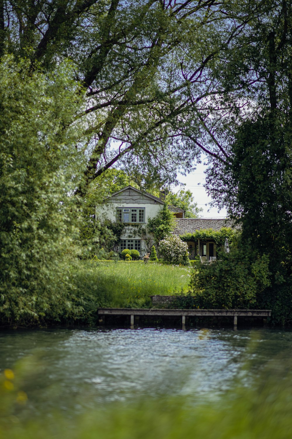 a house sitting on top of a lush green hillside