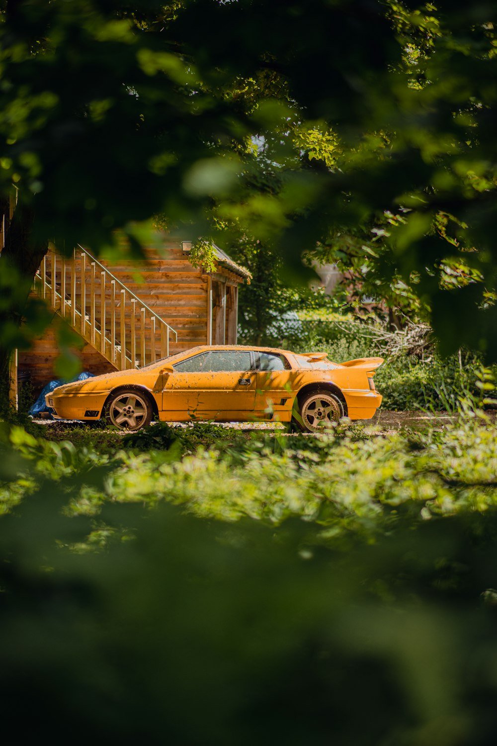 a yellow sports car parked in front of a house