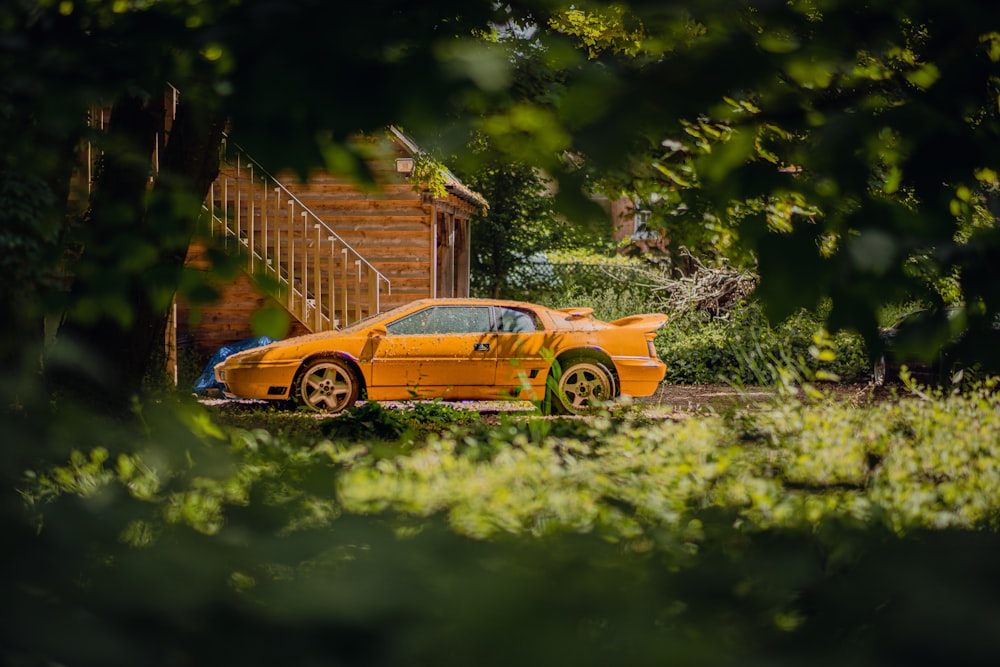 a yellow sports car parked in front of a house