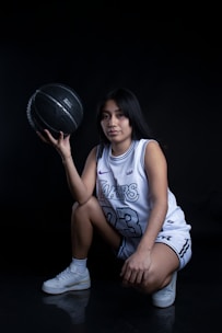Close-up of a basketball player doing strength training with weights in a gym.