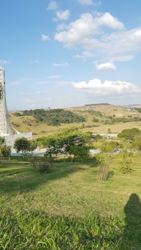 Open green land ready for building with rolling hills in the background.