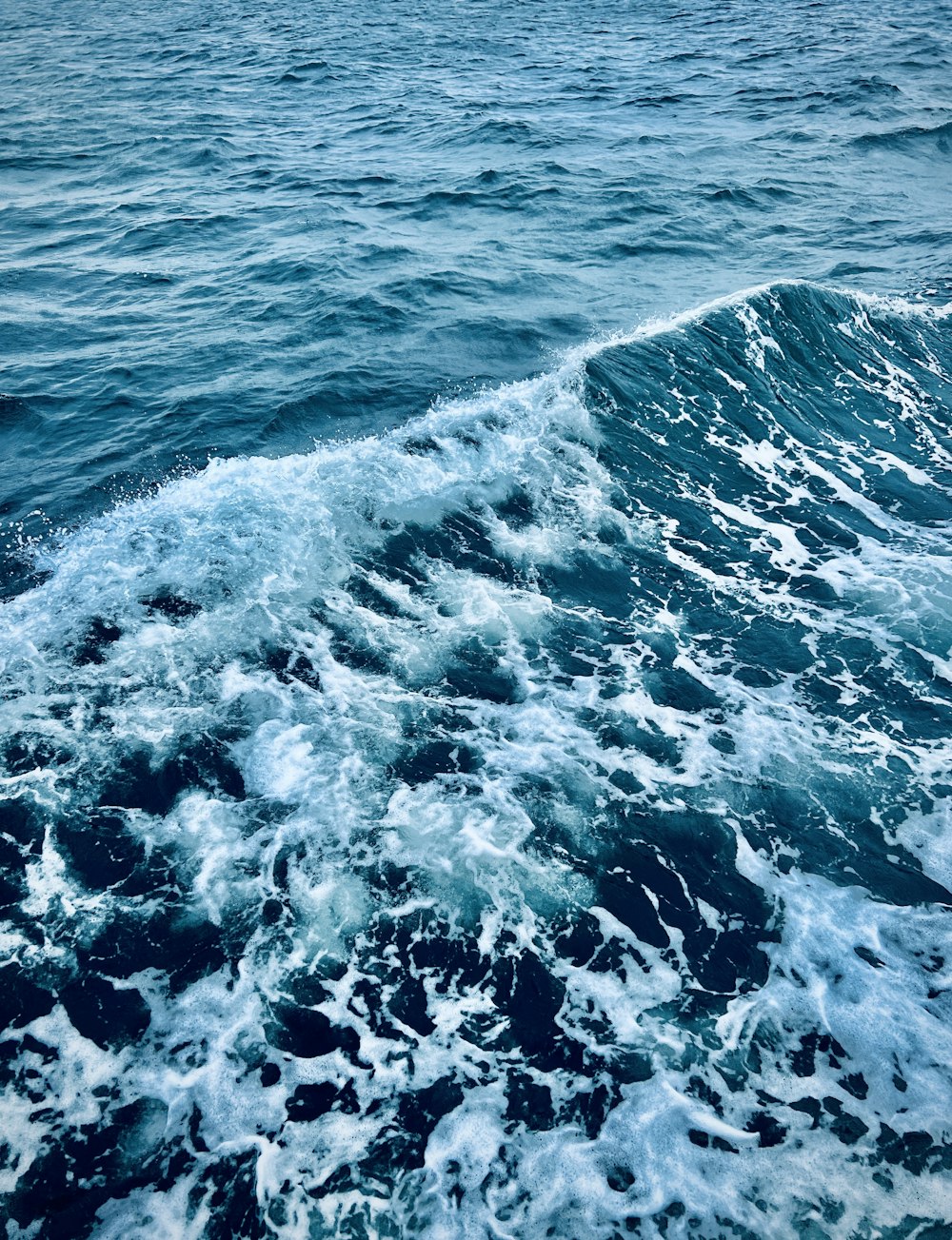 a person riding a surfboard on a wave in the ocean