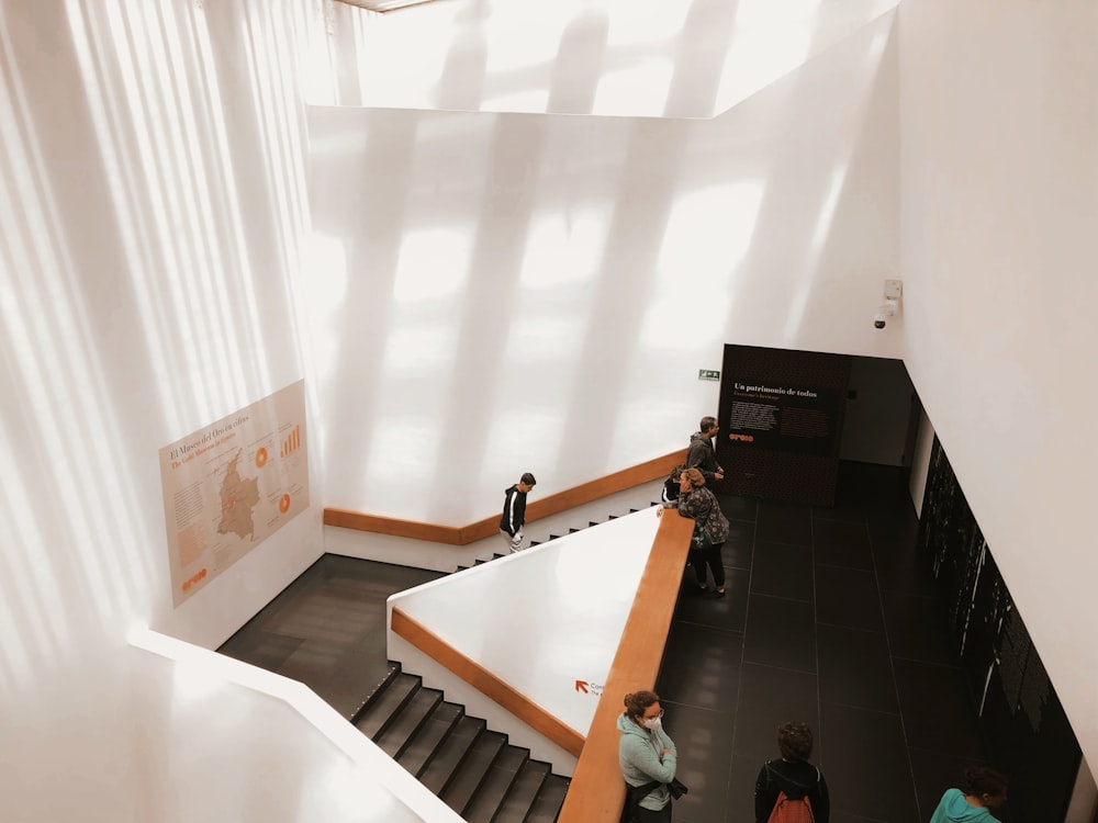 a group of people walking up and down some stairs