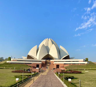a large white building with a long walkway in front of it